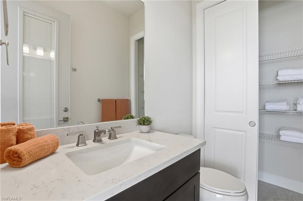 19696 Aqua View Lane Fort Myers, FL 33913 - Photo 37 of 50 a bathroom with a granite countertop sink mirror vanity and toilet