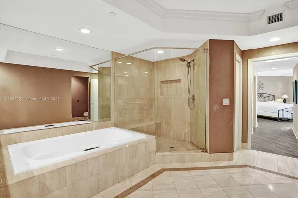 a bathroom with a tub shower and sink