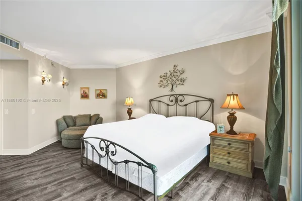 a bedroom with a bed and a mirror on dresser