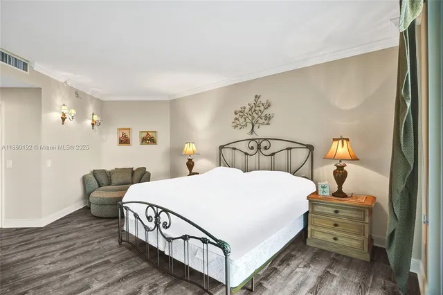 a bedroom with a bed and a mirror on dresser