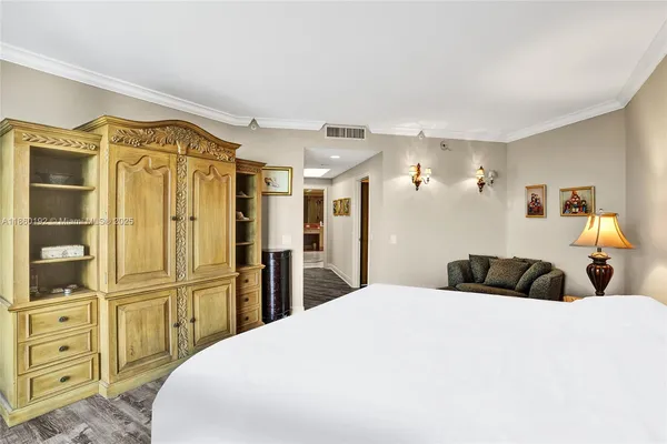 a bedroom with a bed and wooden cabinets