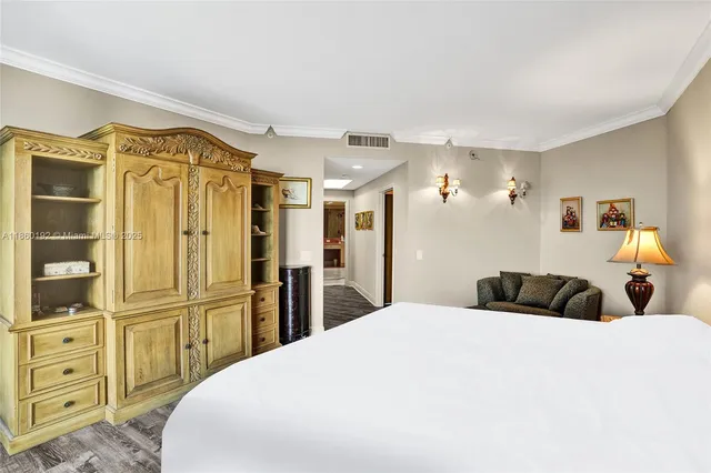a bedroom with a bed and wooden cabinets