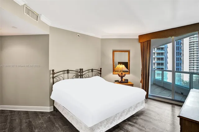 a bed room with a bed and a large window