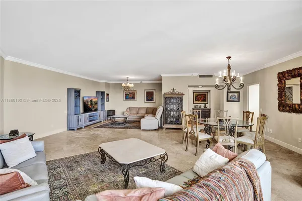 a living room with furniture and a chandelier