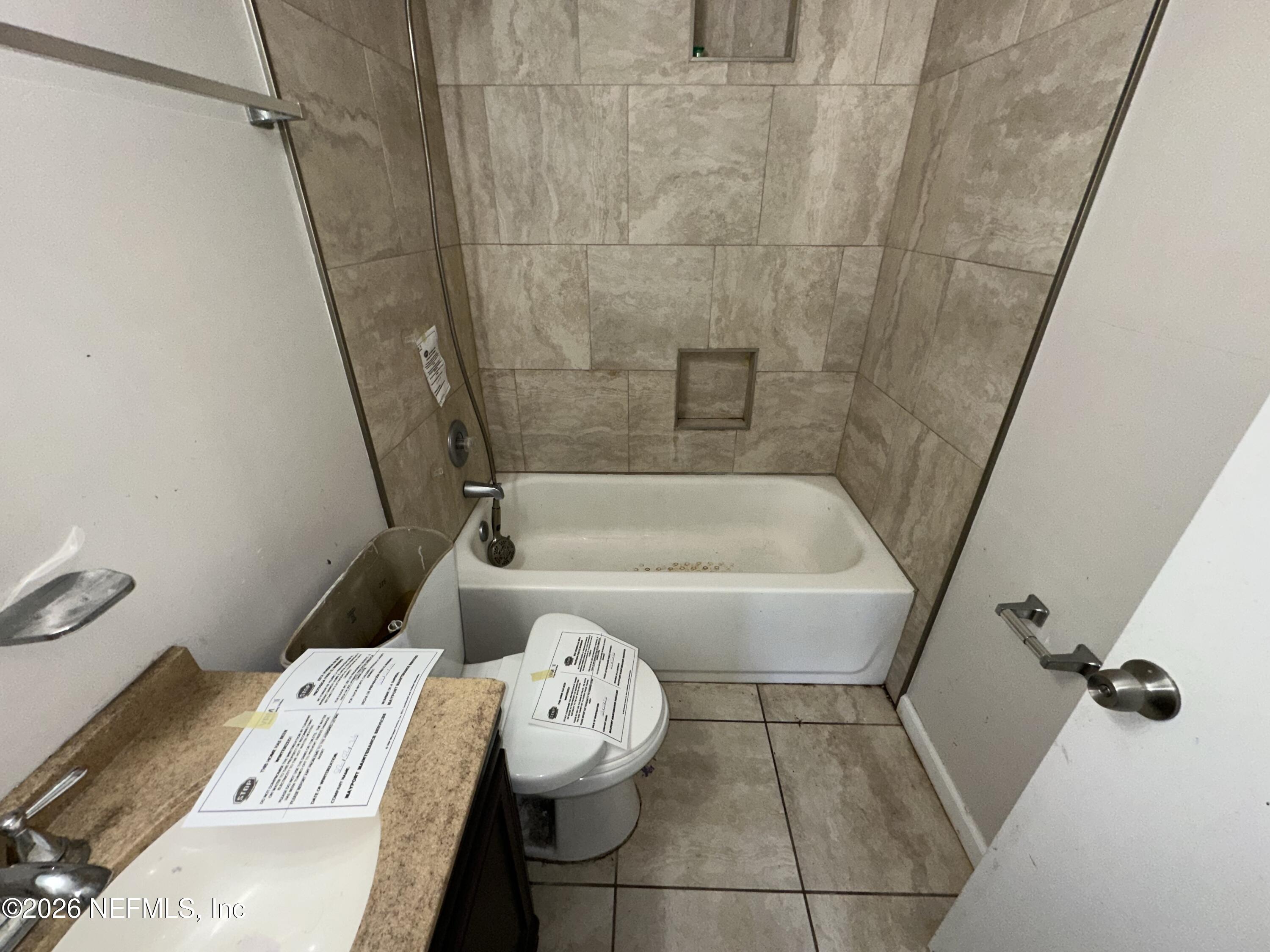 4435 Rainer Road Jacksonville, FL 32210 - Photo 11 of 14 a bathroom with a bathtub and toilet