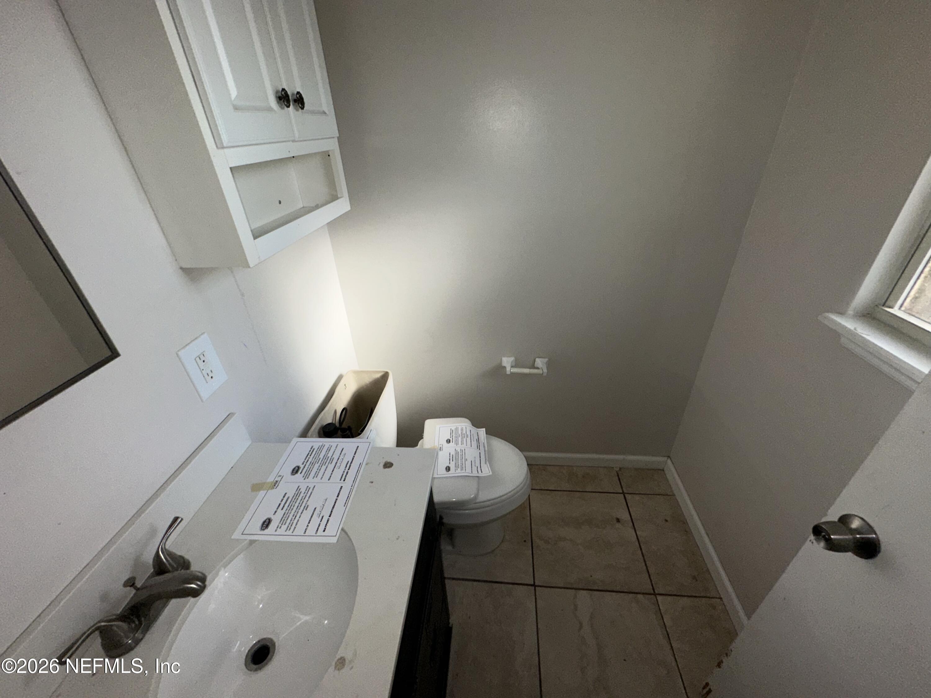 4435 Rainer Road Jacksonville, FL 32210 - Photo 12 of 14 a bathroom with a sink and toilet