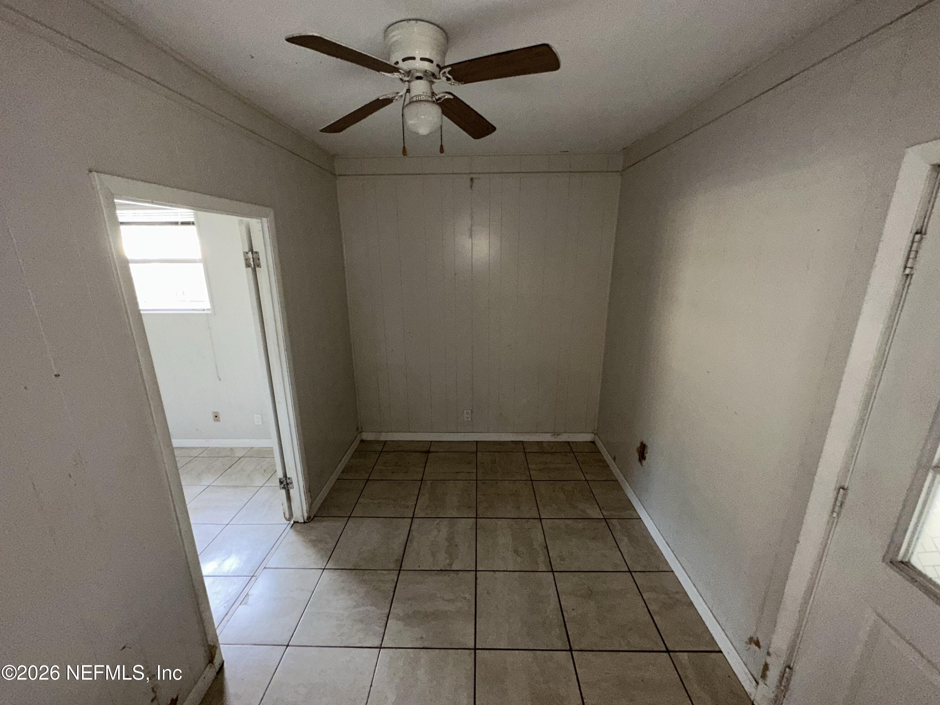 4435 Rainer Road Jacksonville, FL 32210 - Photo 13 of 14 an empty room with wooden floor and windows