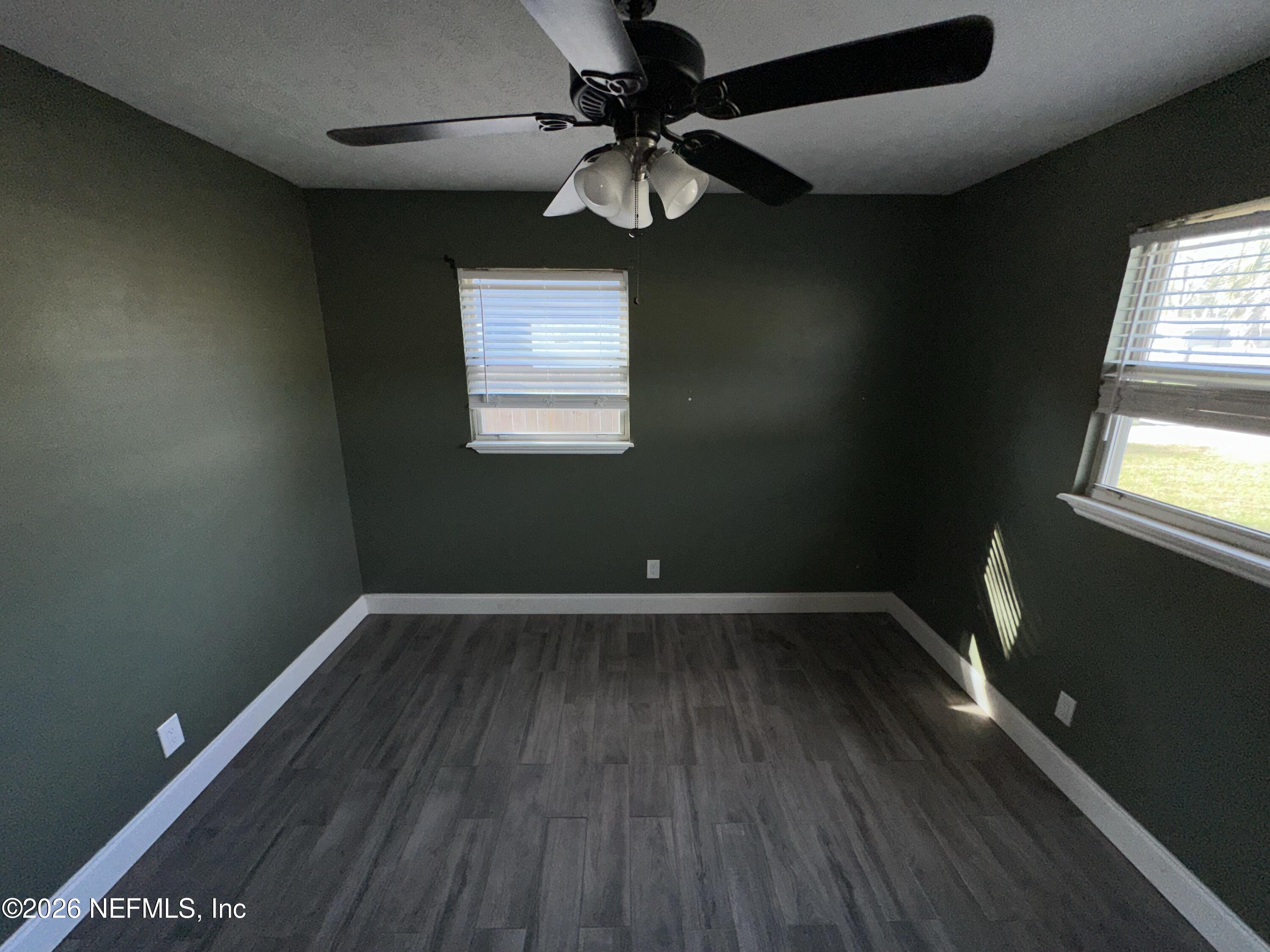 4435 Rainer Road Jacksonville, FL 32210 - Photo 10 of 14 a view of an empty room with wooden floor and a window