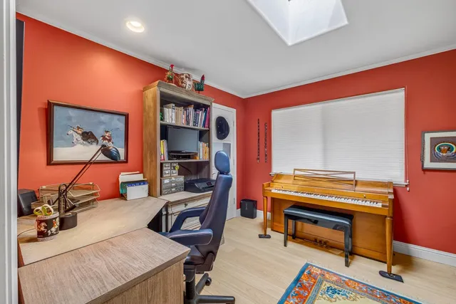 a living room with furniture pool table and a flat screen tv