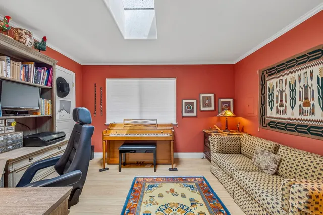 a living room with furniture a rug and a bookshelf