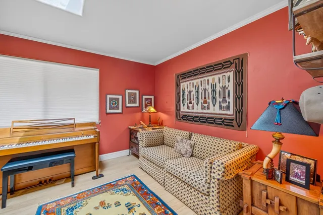 a living room with furniture and a baby crib