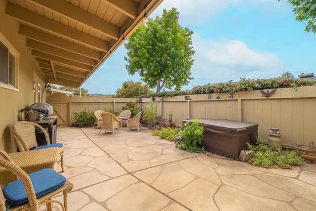 a backyard of a house with outdoor seating