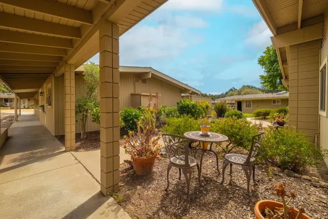 a view of a patio with table and chairs and potted plants