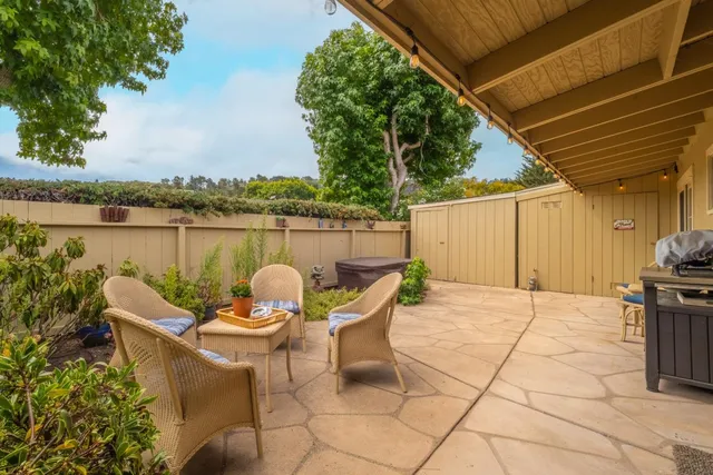 a backyard of a house with outdoor seating