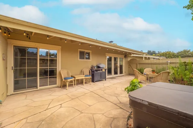 a balcony with table and chairs