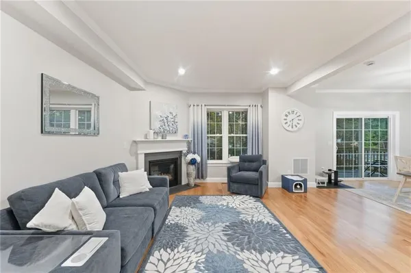 a living room with furniture large window and a fireplace