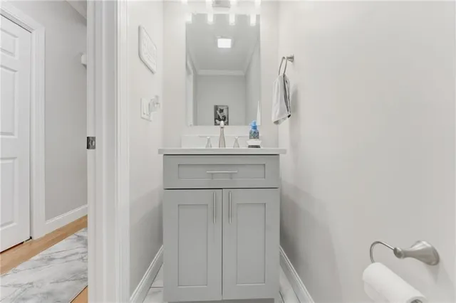 a bathroom with a sink vanity and a mirror