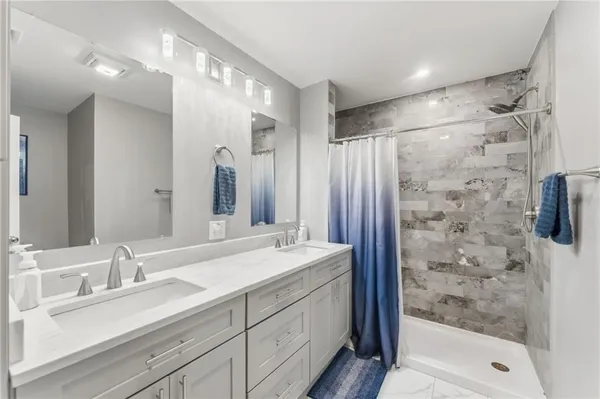 a bathroom with a double vanity sink mirror double shower and a