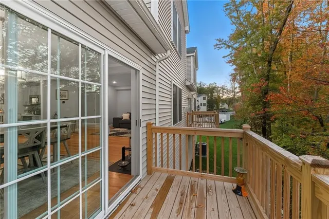 a view of a balcony with wooden floor and fence