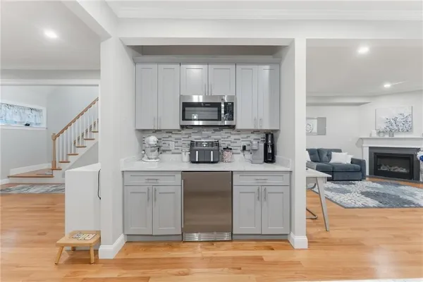 a kitchen with stainless steel appliances granite countertop a stove top oven a sink and a microwave