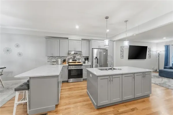 a kitchen with a sink stove and refrigerator