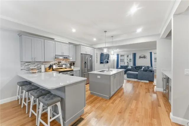 a kitchen with a sink a counter top space and stainless steel appliances