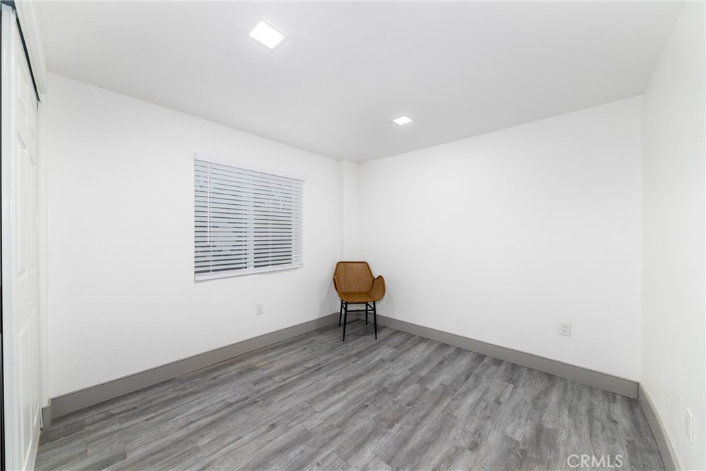 2127 Tenth Street, Unit A Riverside, CA 92507 - Photo 13 of 13 a view of a room with wooden floor and a window