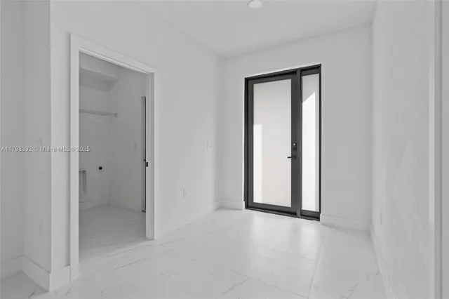 a view of an empty room with a bathroom