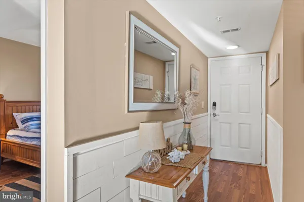 a living room with furniture cabinets and a large window