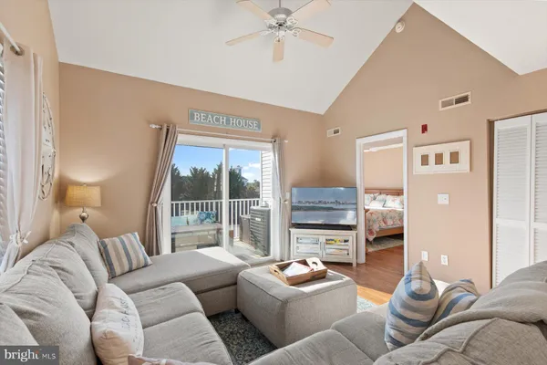 a kitchen with a refrigerator a stove top oven a sink a dining table and chairs