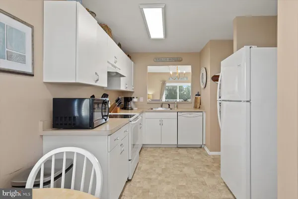 a kitchen with a sink a refrigerator and window