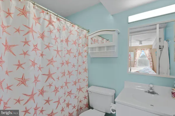 a bathroom with a sink and mirror with toilet