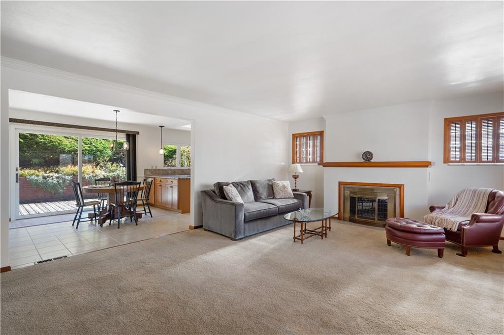 227 Old Clairton Road Pittsburgh, PA 15236 - Photo 3 of 22 a living room with furniture a fireplace and a floor to ceiling window