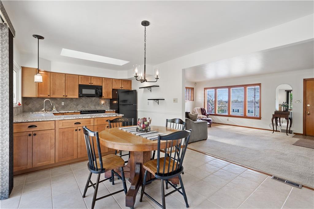 227 Old Clairton Road Pittsburgh, PA 15236 - Photo 6 of 22 a dining area with a table chairs and a kitchen view
