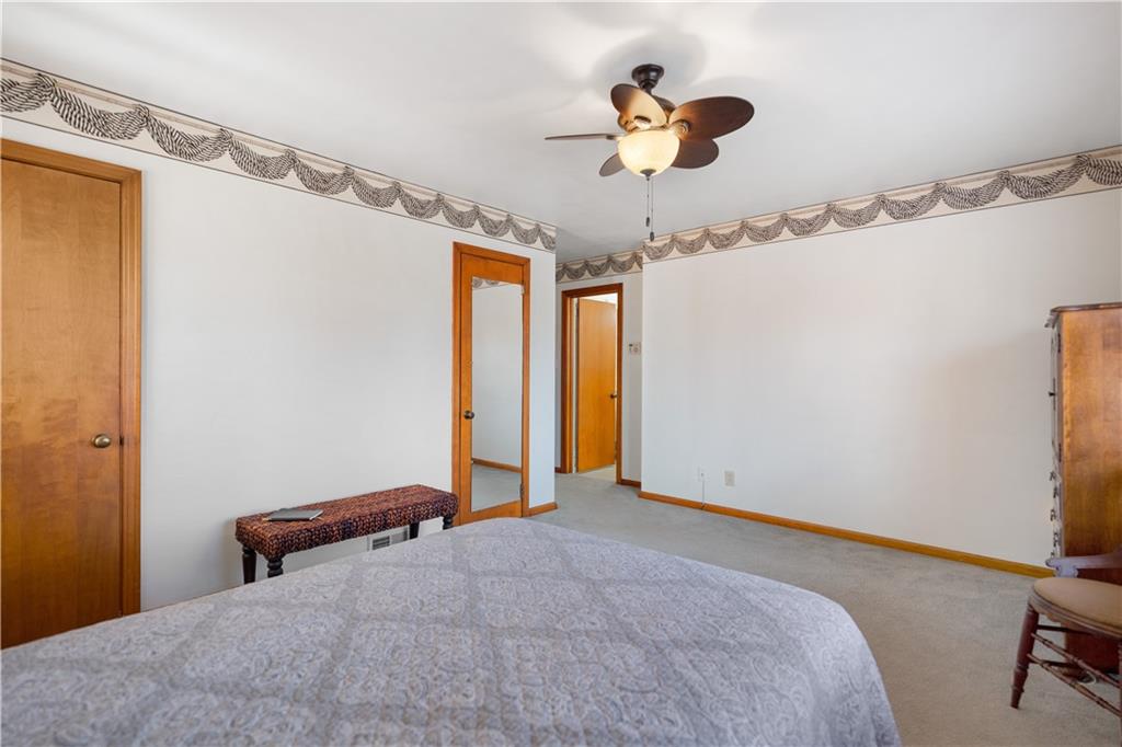 227 Old Clairton Road Pittsburgh, PA 15236 - Photo 9 of 22 a bedroom with a bed and a chandelier