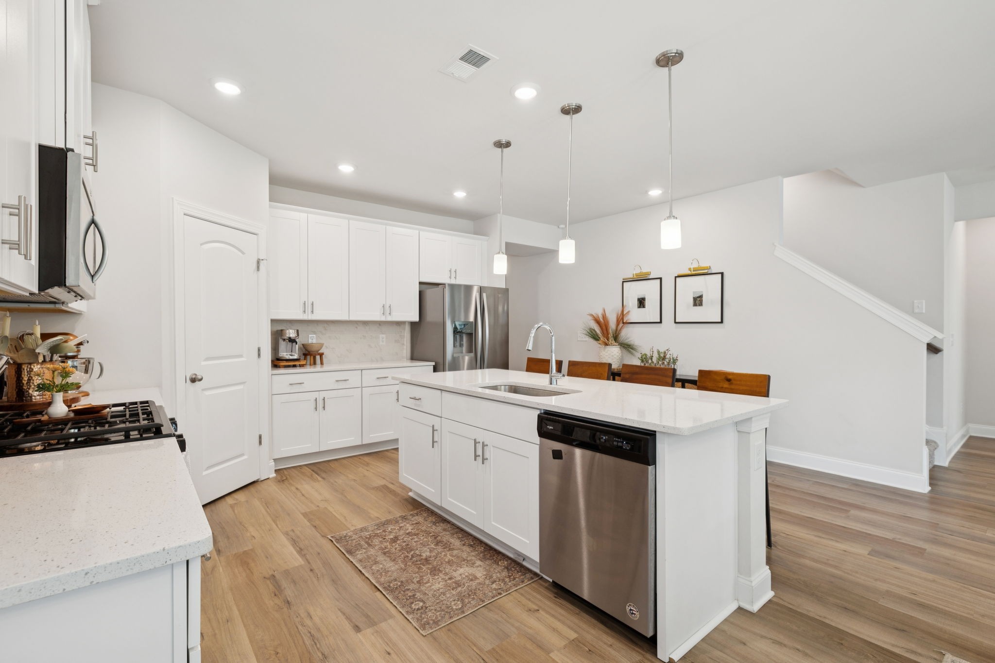 3316 Longstalk Road Antioch, TN 37013 - Photo 13 of 40 a kitchen with white cabinets appliances and wooden floor