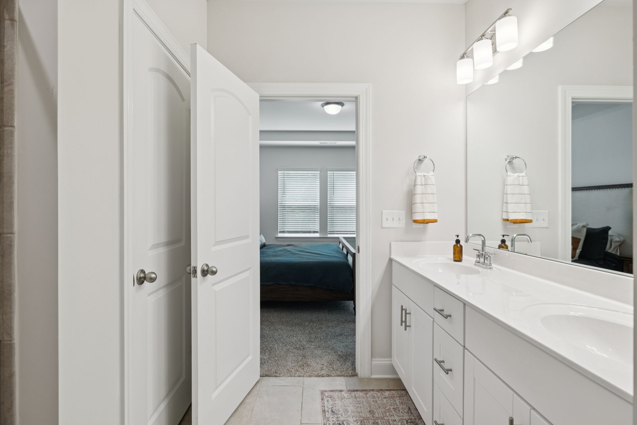 3316 Longstalk Road Antioch, TN 37013 - Photo 25 of 40 a en suite bathroom with a double sink a large mirror and a bathtub