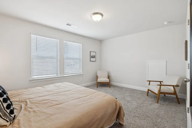 a view of a hallway with wooden floor and a potted plant