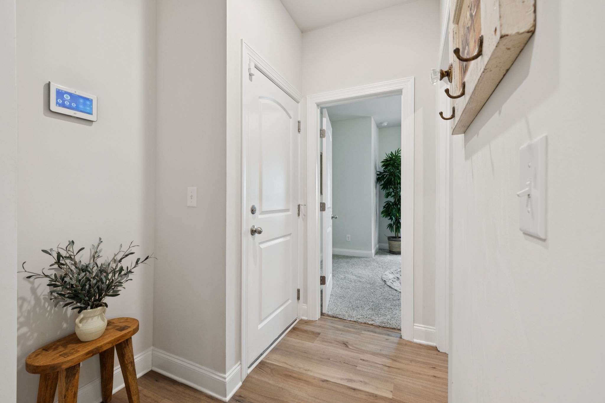 3316 Longstalk Road Antioch, TN 37013 - Photo 31 of 40 a view of a hallway with wooden floor and a potted plant