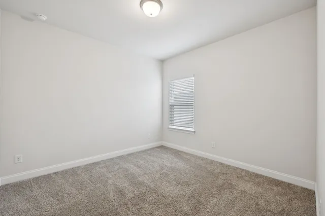a view of a livingroom with a window and a ceiling fan