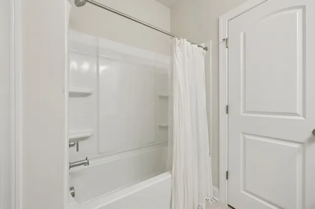 a kitchen with stainless steel appliances kitchen island granite countertop a table chairs and a refrigerator