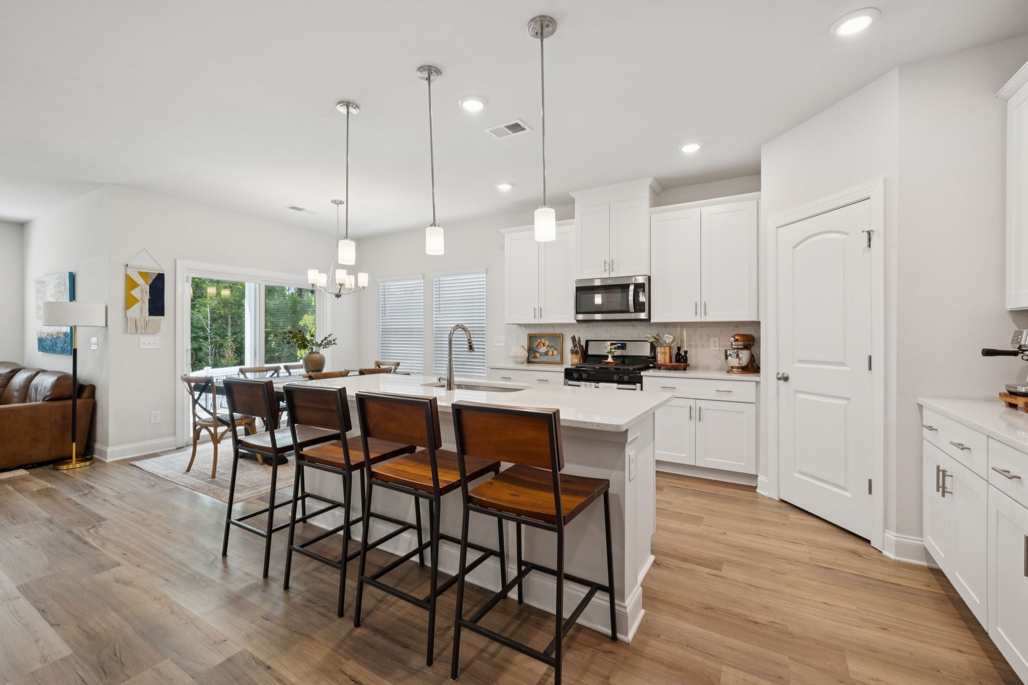 3316 Longstalk Road Antioch, TN 37013 - Photo 10 of 40 a kitchen with stainless steel appliances kitchen island granite countertop a table chairs and a refrigerator
