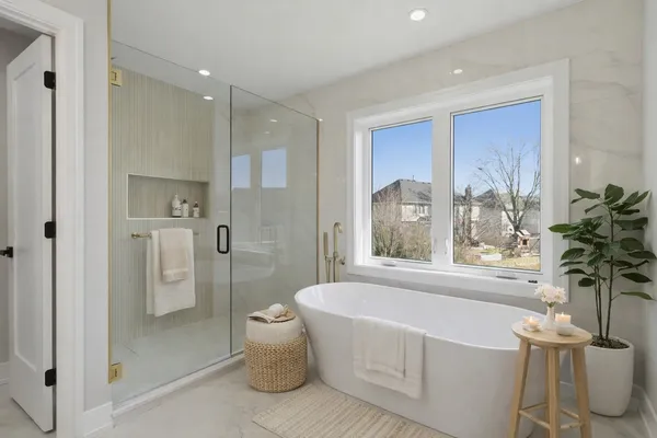 a spacious bathroom with a bathtub and shower