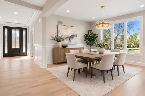 a dining room with furniture window and wooden floor