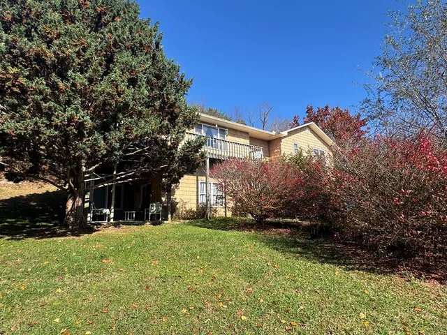 a view of house with yard