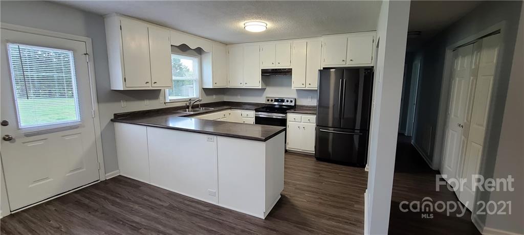 3560 Boggs Road Claremont, NC 28610 - Photo 1 of 15 a kitchen with a refrigerator stove and sink