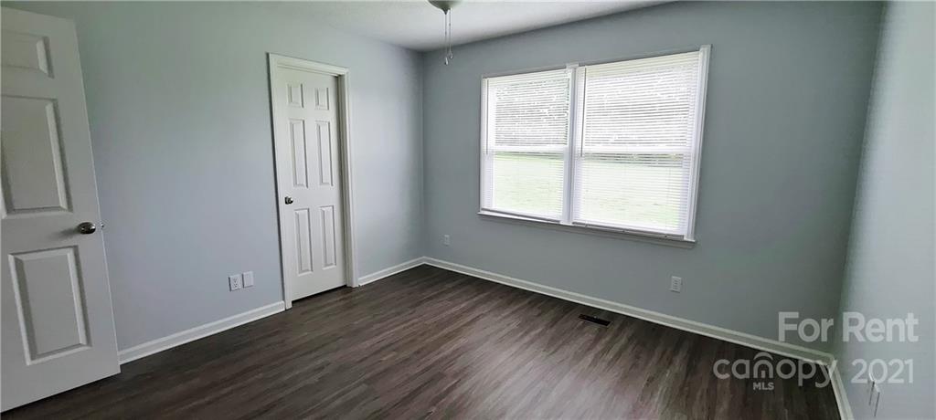 3560 Boggs Road Claremont, NC 28610 - Photo 12 of 15 an empty room with wooden floor and windows