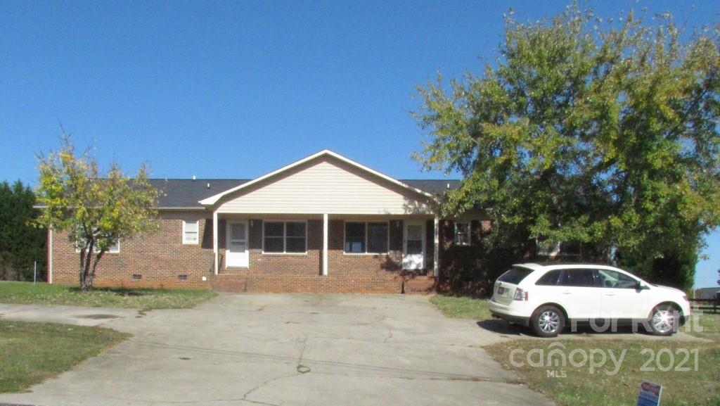 3560 Boggs Road Claremont, NC 28610 - Photo 15 of 15 a white house covered with tall trees