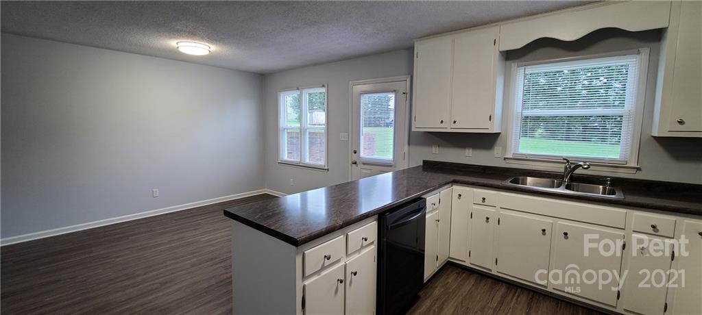 3560 Boggs Road Claremont, NC 28610 - Photo 3 of 15 a kitchen with granite countertop white cabinets and a window
