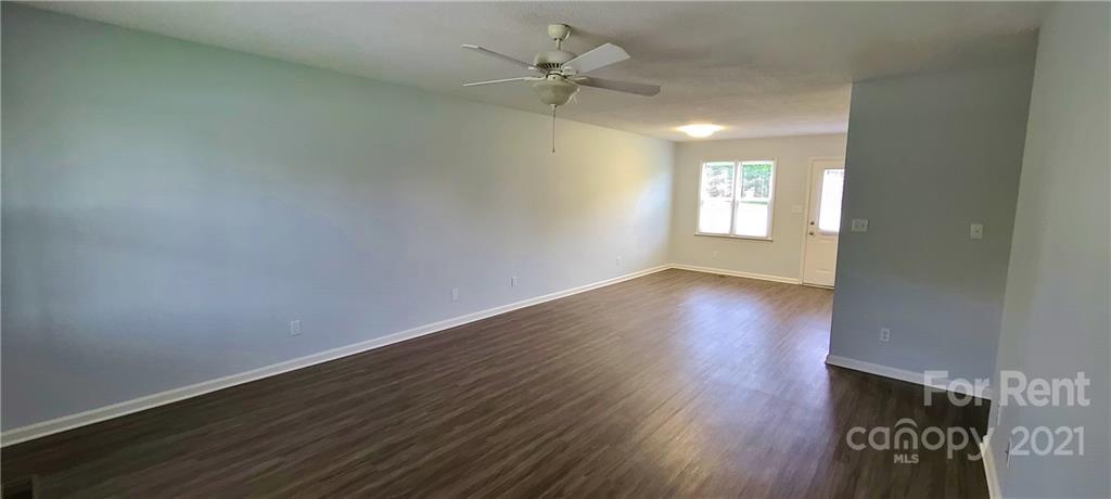 3560 Boggs Road Claremont, NC 28610 - Photo 5 of 15 wooden floor in an empty room with a window